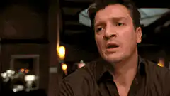 Bourne holding a coin