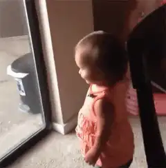 Toddler dancing by the window
