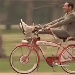 Man riding bicycle with shoes on handlebars