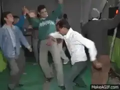 Man in white shirt kicks another man in green sweater