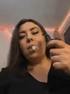 woman exhaling smoke ring