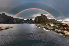 Double rainbow over coastal village