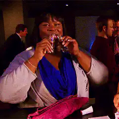 Woman drinking from two shot glasses