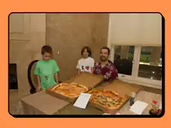 Family with two pizzas