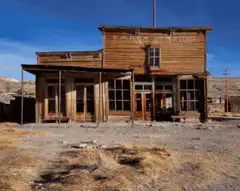 Tumbleweeds rolling past an old western building
