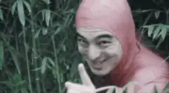 Man in red suit winking in bamboo