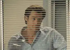 Andy Dwyer winking through blinds