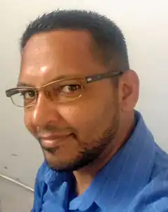 Man in glasses and blue shirt