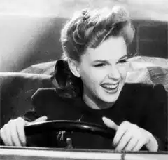 Judy Garland laughing while driving