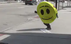 Smiley face mascot trips and falls