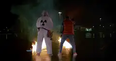 Two men on fire at night