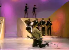 Elton John sweeps stage with broom