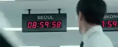 Man watches clock hit midnight in Seoul