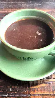 Steaming hot chocolate in green mug