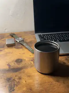 Coffee cup on desk with laptop