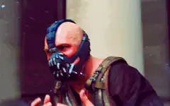 Bane adjusting his mask