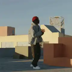 Man in red beanie dancing on rooftop