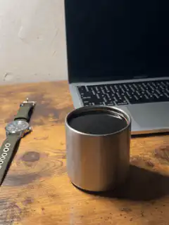 Coffee cup on desk with laptop