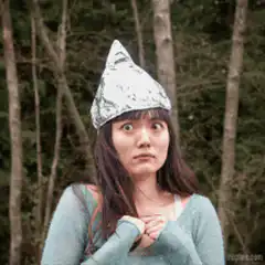 Woman in tinfoil hat looking up