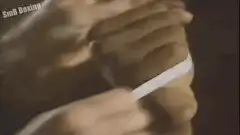 Mike Tyson wrapping hands and standing in ring