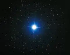bright blue star in starry night sky