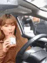 Woman drinking coffee in car