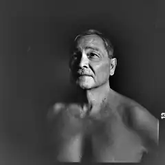 Black and white portrait of shirtless older man
