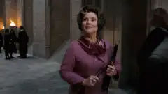 Madam Malkin smugly holding an umbrella