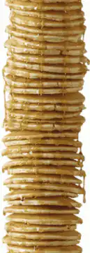 Towering stack of pancakes with syrup