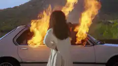 Woman walks away from burning car