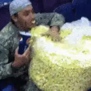 Man eating popcorn and drinking soda