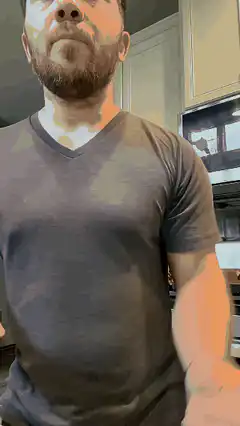 Man in kitchen making a gesture