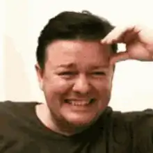 Man facepalms while laughing