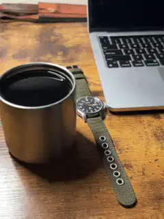 coffee cup and watch on desk