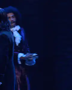 Aaron Burr reads a letter in Hamilton