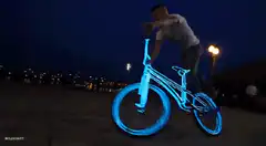glowing blue bike trick