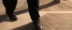Close-up of feet walking on pavement