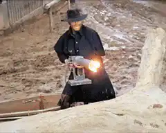Man on fire runs and falls in mud
