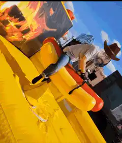 Man riding inflatable bull