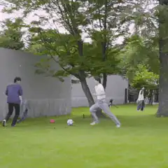 people playing soccer in a yard