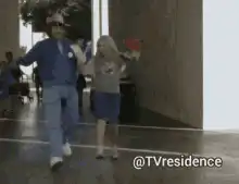 Man and girl running and waving
