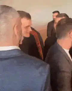 Man in black shirt smiles at event