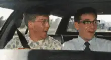 Three men laughing in a car