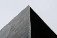 Modern building corner against sky