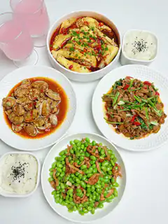Chinese food spread with rice and drinks