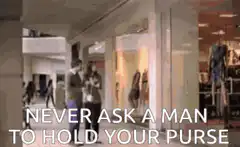 Man holds purse then claps with friends