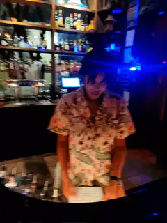 bartender in floral shirt dancing