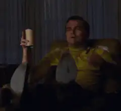 Leonardo DiCaprio pointing with a drink