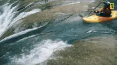 Kayaker goes over waterfall