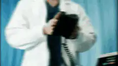 Doctor uses defibrillator on patient